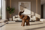 Natural Wonders USA dark wood elephant figurine with raised trunk, carved details, and natural grain.