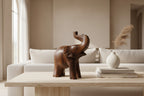 Natural Wonders USA dark wood elephant figurine with raised trunk, carved details, and natural grain.