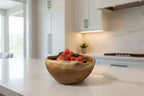 Natural Wonders USA rustic wooden serving bowl with unique grain pattern, filled with red grapes and an apple.