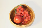 Natural Wonders USA rustic wooden serving bowl with organic shape and irregular rim, filled with red apple and coral grapes.