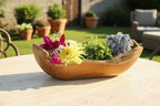 Natural Wonders USA rustic wooden trough centerpiece filled with colorful flowers and greenery. Handcrafted from solid wood with organic shape.